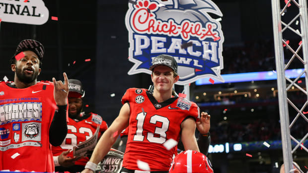 Dec 31, 2022; Atlanta, Georgia, USA; Georgia Bulldogs quarterback Stetson Bennett (13) celebrates after a victory against the Ohio State Buckeyes in the 2022 Peach Bowl at Mercedes-Benz Stadium.
